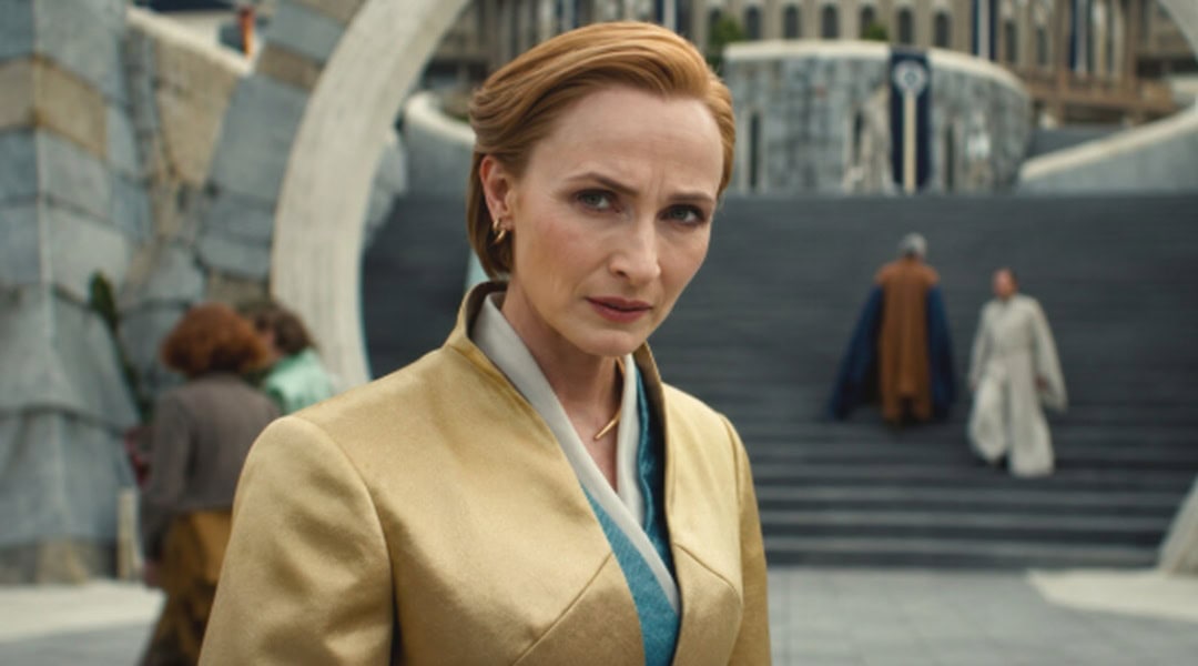 Close-up of a woman in a beige costume with a serious expression, set in a sci-fi cityscape backgrou.